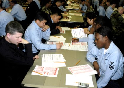 US Navy 060119-N-2385R-036 Sailors review their answer sheets prior to taking the Chief Petty Officers' (CPO) exam photo