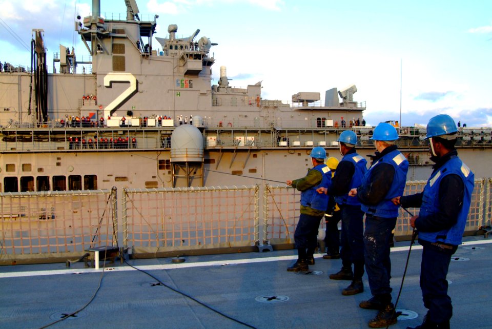 US Navy 060205-N-4772B-126 The amphibious dock landing ship USS Harpers Ferry (LSD 49) Sailors tend a station to station phone line with the amphibious assault ship USS Essex (LHD 2), during a scheduled underway replenishment (