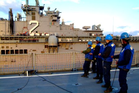 US Navy 060205-N-4772B-126 The amphibious dock landing ship USS Harpers Ferry (LSD 49) Sailors tend a station to station phone line with the amphibious assault ship USS Essex (LHD 2), during a scheduled underway replenishment (
