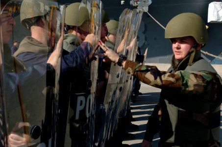 US Navy 060111-N-9866B-012 Master-at-Arms 1st Class Edward Henriksen tests the strength of a riot control team consisting of duty section Sailors photo