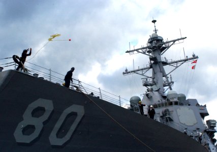 US Navy 060208-N-0780F-006 A Sailor stationed aboard the guided-missile destroyer USS Roosevelt (DDG 80) throws a heaving line to the pier during mooring operations