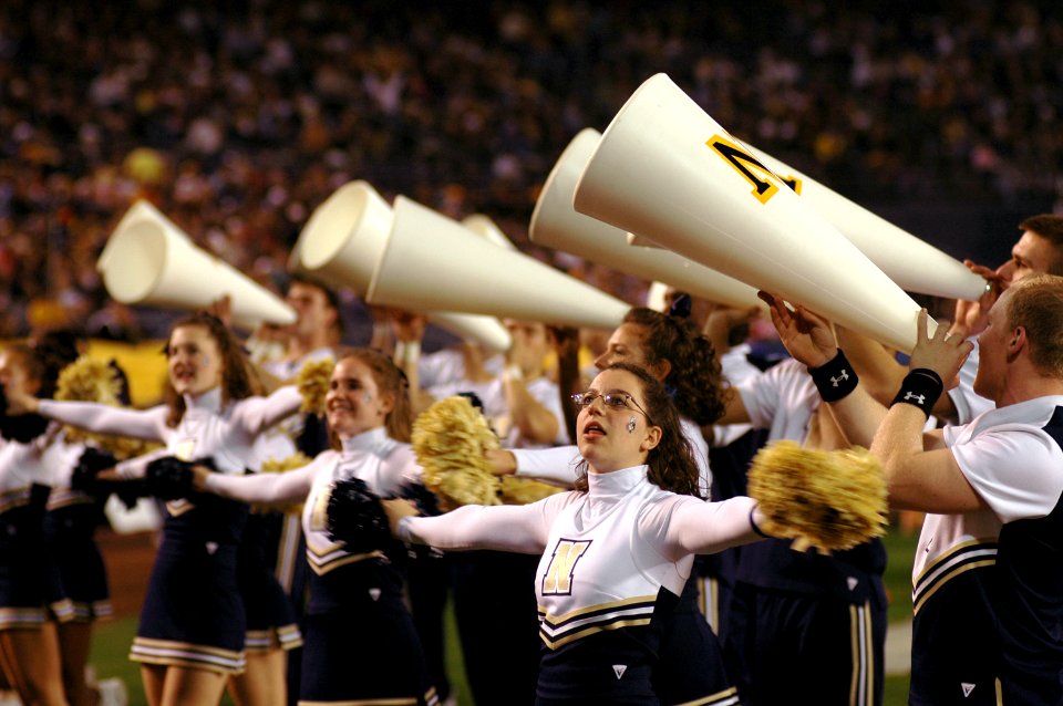 US Navy 051222-N-9866B-539 U.S. Naval Academy Midshipmen cheerleaders show team spirit during the inaugural Poinsettia Bowl