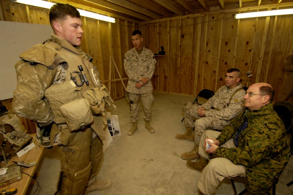 US Navy 060128-N-2568S-006 Secretary of the Navy (SECNAV) Dr. Donald C. Winter receives a briefing from Lt. Col. Chris Wagner, center, on the personal protective gear worn by Marines operating in Iraqi