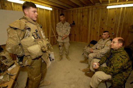 US Navy 060128-N-2568S-006 Secretary of the Navy (SECNAV) Dr. Donald C. Winter receives a briefing from Lt. Col. Chris Wagner, center, on the personal protective gear worn by Marines operating in Iraqi