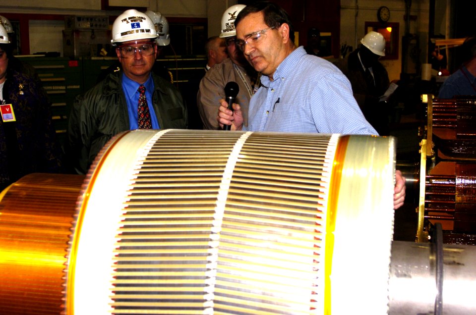 US Navy 060120-N-2568S-185 Motor Section Supervisor, Stephen Thayer, explains to Secretary of the Navy (SECNAV) the Honorable Dr. Donald C. Winter the maintenance being performed on a motor generator set