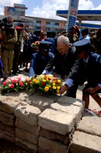 US Navy 060126-F-2902B-159 U.S. Ambassador to Kenya, William Bellamy, lays down a flower wreath near the destruction site during a memorial service