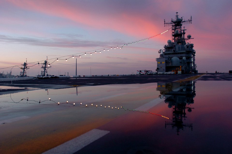 US Navy 060101-N-9866B-363 The amphibious assault ship USS Peleliu (LHA 5) home ported at Naval Station San Diego displays her holiday lights in celebration during the first morning sunrise of the New Year