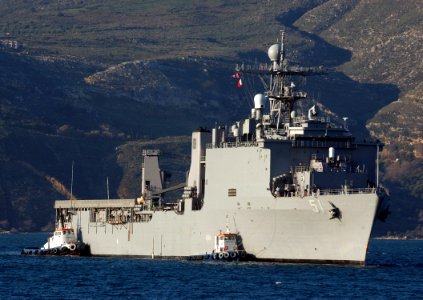US Navy 060209-N-0780F-002 Tug boats assist the dock landing ship USS Oak Hill (LSD 51) as she arrives for a routine port visit to Greece's largest island