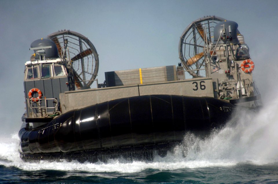US Navy 060126-N-4374S-005 A Landing Craft Air Cushion (LCAC), assigned to Assault Craft Unit Four (ACU-4), makes a final approach to embark aboard the dock landing ship USS Carter Hall (LSD 50)