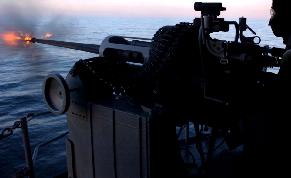 US Navy 060117-N-9866B-123 Airman Scutt Prophete fires a MK-38 25 mm machine gun during a familiarization fire (FAMFIRE) aboard the amphibious assault ship USS Peleliu (LHA 5)