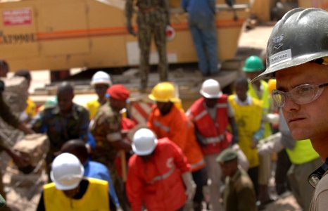 US Navy 060125-F-2902B-156 U.S. Navy Seabee Petty Officer 3rd Class Jason Blanchard, prepare to help remove debris from a building that collapsed on Nairobi's Ronald Ngala Street Kenya, Africa, Jan. 24, 2006
