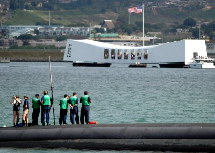 US Navy 060210-N-3019M-006 Sailors stationed aboard the Los Angeles-class fast attack submarine USS Louisville (SSN 724) watch as the submarine pass the USS Arizona Memorial
