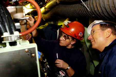 US Navy 060119-N-2568S-117 Electric Boat employee, Sara Conahye shows Secretary of the Navy (SECNAV), the Honorable, Dr. Donald C. Winter the proper procedure for creating a connection point for fiber optic cable