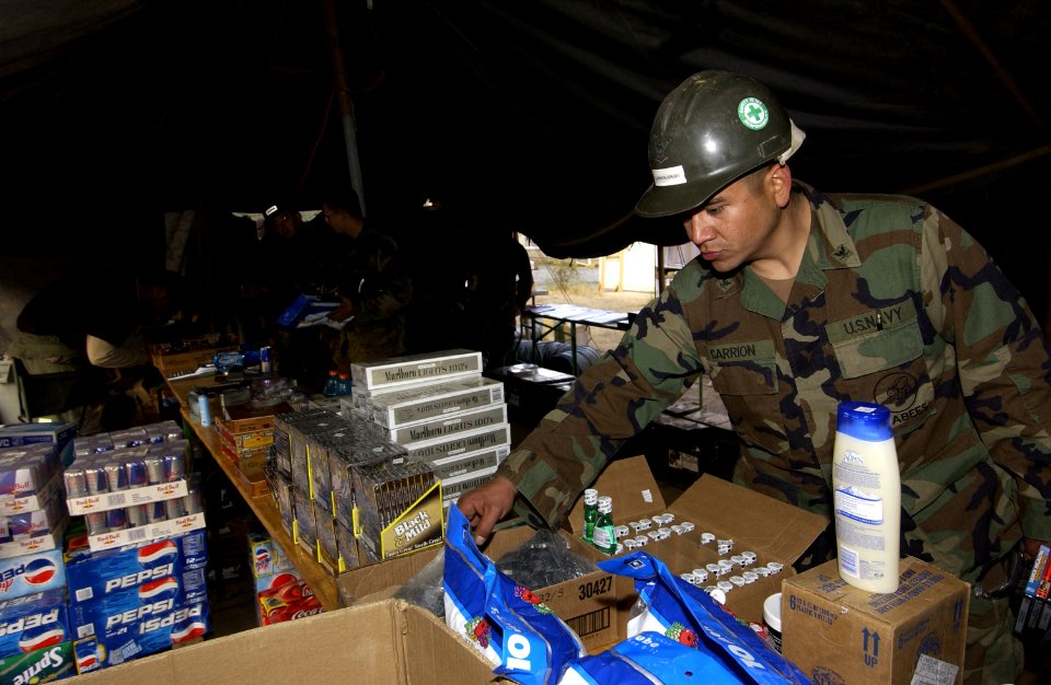 US Navy 060105-F-2729L-017 U.S. Navy Petty Officer 3rd Class Javier Carrion-Junqui assigned to Naval Mobile Construction Battalion Four (NMCB-4), shops at a forward deployed Army and Air Force Exchange Service store in Muzaffar