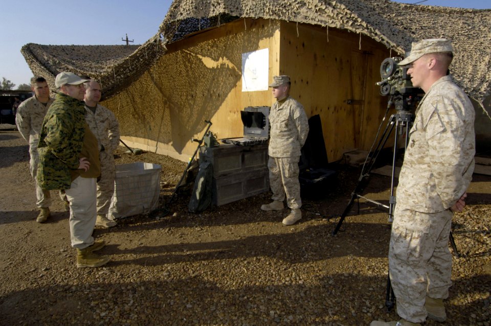 US Navy 060129-N-2568S-022 Marines explain to the Secretary of the Navy (SECNAV), the Honorable Dr. Donald C. Winter, the operation of equipment used to detect explosive devices attached to potential suicide bombers