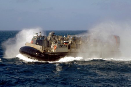US Navy 060126-N-4374S-002 A Landing Craft, Air Cushion (LCAC), assigned to Assault Craft Unit Four (ACU-4), departs for a training mission photo
