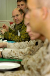 US Navy 060127-N-2568S-032 Secretary of the Navy (SECNAV) Dr. Donald C. Winter eats dinner with Brig. Gen. John Wissler, Commanding General 2nd Marine Logistics Group, and Sailors and Marines stationed at Al Taqaddum