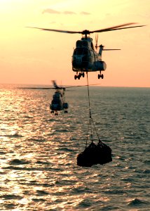 US Navy 060131-N-5248R-004 Two SA-330 Puma helicopters deliver supplies to the Nimitz-class aircraft carrier USS Theodore Roosevelt (CVN 71) from the Military Sealift Command (MSC) combat stores ship USNS Spica (T-AFS 9)