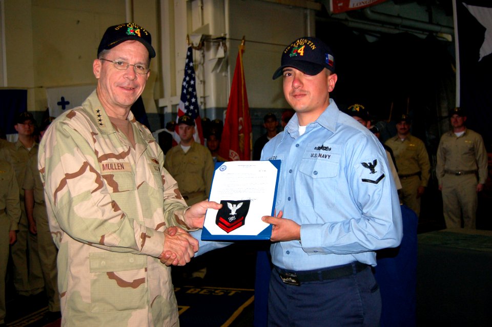 US Navy 060109-N-0000X-003 Chief of Naval Operations, Adm. Mike Mullen, advances Electronics Technician 3rd Class Roberto Acevedo to 2nd Class Petty Officer