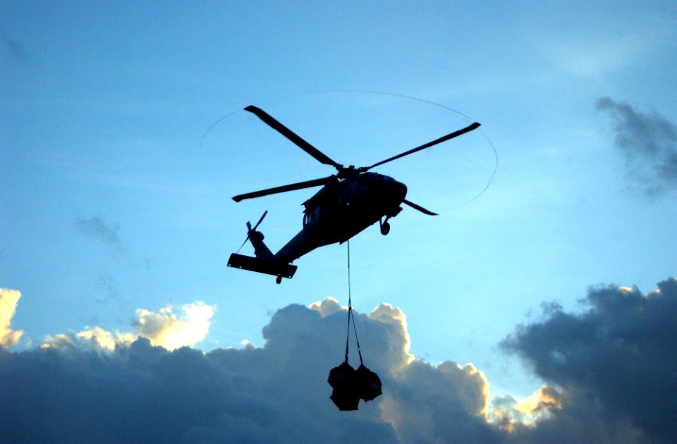 US Navy 060205-N-4776G-410 An MH-60S Seahawk helicopter delivers supplies from the Military Sealift Command (MSC) combat stores ship USNS Niagara Falls (T-AFS 3)