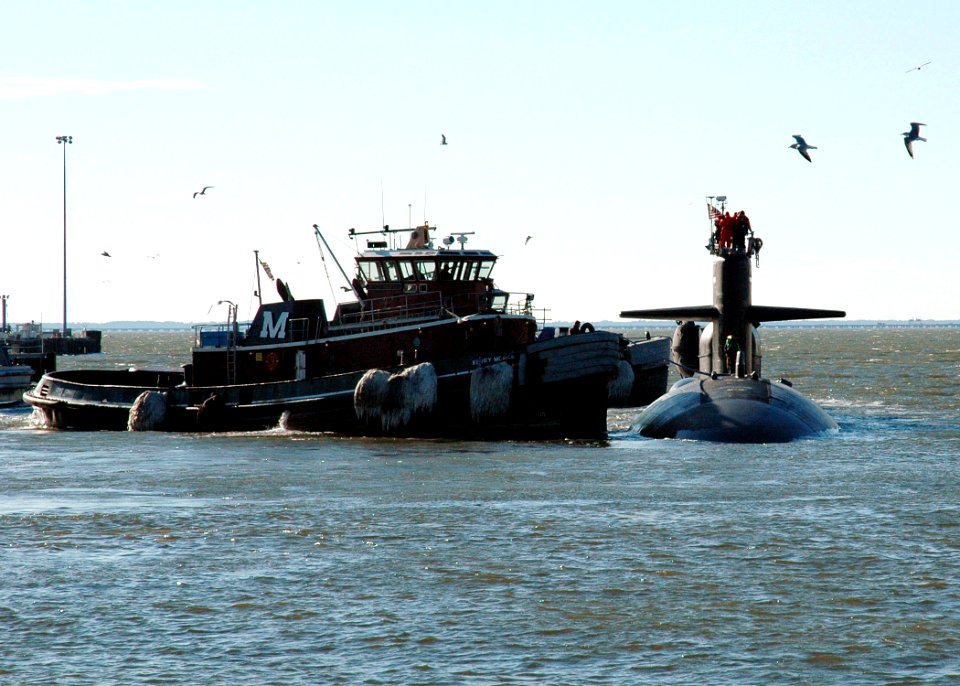 US Navy 060206-N-1464F-012 - A Navy tugboat pulls alongside the Los Angeles-class fast attack submarine USS Dallas (SSN 700), as the fast attack submarine gets underway in support of a Special Warfare Training exercise