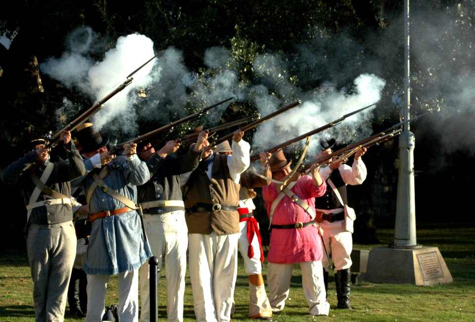 US Navy 060111-N-2736O-001 The Alamo Ceremonial Guard fires their muskets during a 21-gun salute at a ceremony with the crew members assigned to the amphibious transport dock ship USS San Antonio (LPD 17)