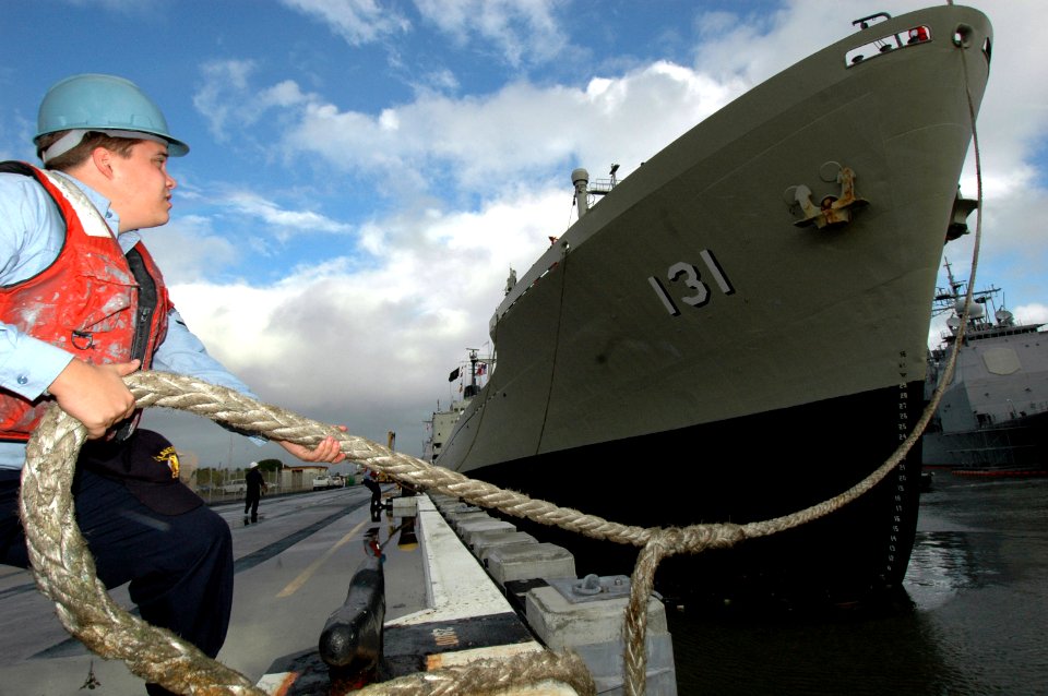 US Navy 060125-N-3019M-002 Sonar Technician 3rd Class Kevin Mankins casts off the Peruvian transport ship BAP Mollendo (ATC 131) after the ships four-day port visit to Pearl Harbor