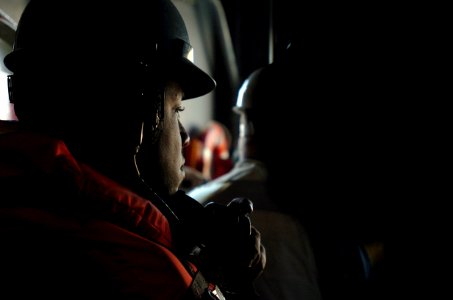 US Navy 060114-N-9866B-024 A Sailor assigned to the Deck Department awaits instructions to relay a message to his shipmates