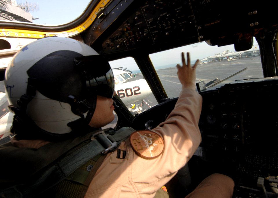 US Navy 060202-N-2838C-016 A pilot assigned to the Rawhides of Fleet Logistics Support Squadron Four Zero (VRC-40) Detachment One signals to the plane captain
