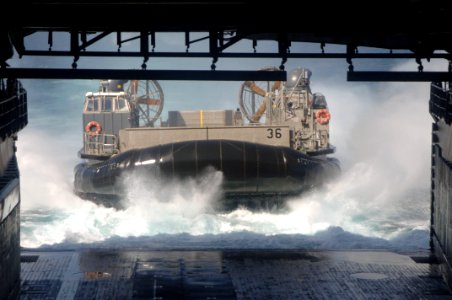 US Navy 060126-N-4374S-006 A Landing Craft, Air Cushion (LCAC), assigned to Assault Craft Unit Four (ACU-4), approaches the well deck of dock landing ship USS Carter Hall (LSD 50) photo