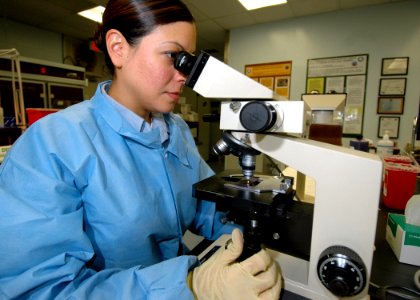 US Navy 060207-N-3019M-006 Hospital Corpsman 2nd Class Vanessa Smith, assigned to Navy Environmental and Preventative Medicine Unit Six (NEPMU-6), examines an organism sample through a microscope