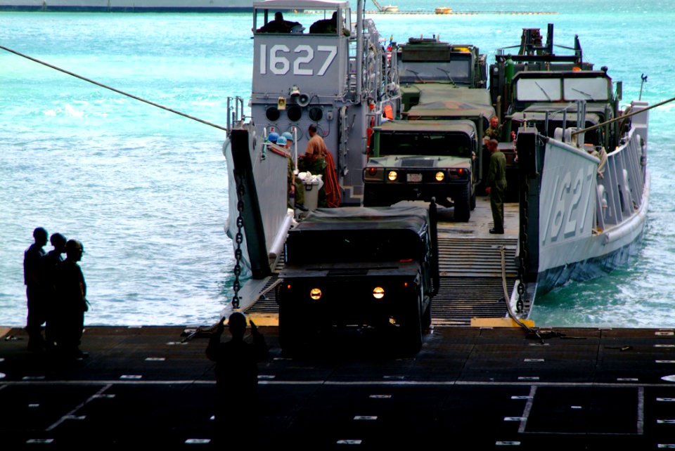 US Navy 060209-N-4772B-237 The amphibious dock landing ship USS Harpers Ferry (LSD 49) Sailors direct equipment assigned to the 31st Marine Expeditionary Unit (MEU) into the well deck