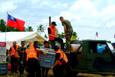 US Navy 060222-N-4772B-144 Philippine Army and Turkish rescue workers unload a vehicle filled with relief supplies during rescue efforts following a devastating landslide that struck southern Leyte on Feb. 17, 2006
