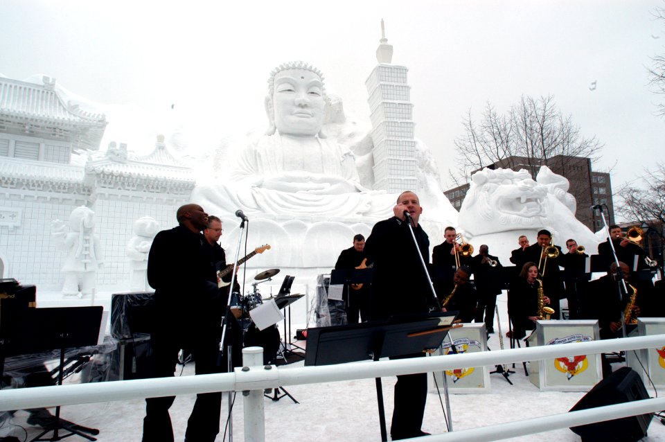 US Navy 060208-N-1194D-003 Musician 2nd Class A.C. Smith, left, Musician 2nd Class Tommy Horner, center, and the rest of the 7th Fleet Band's big band Far East Edition perform for hundreds of spectators on a stage made entirely