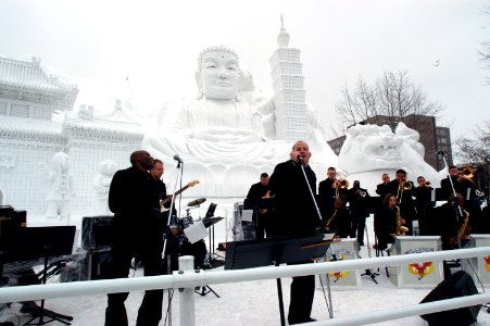 US Navy 060208-N-1194D-003 Musician 2nd Class A.C. Smith, left, Musician 2nd Class Tommy Horner, center, and the rest of the 7th Fleet Band's big band Far East Edition perform for hundreds of spectators on a stage made entirely