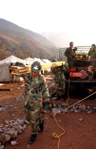 US Navy 060120-F-4462M-002 U.S. Navy Seabees assigned to Naval Mobile Construction Battalion Four (NMCB-4)) build a temporary school in the mountains near Muzaffarabad, Pakistan photo