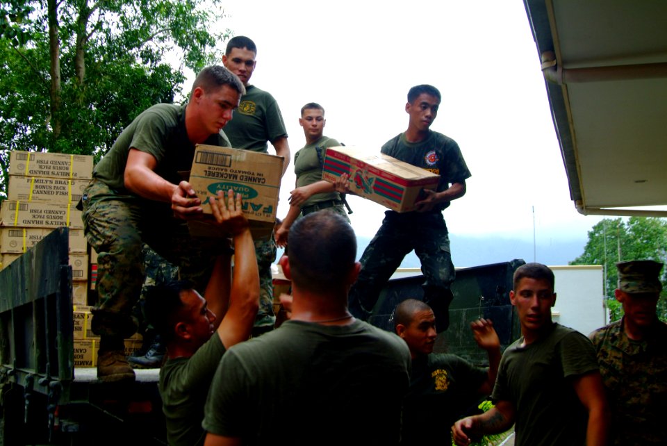US Navy 060224-N-4772B-243 U.S. Marines assigned to the 31st Marine Service Support Group (MSSG) work together with Philippine Marines loading supplies into a truck in support of relief efforts after a massive Feb. 17 landslide