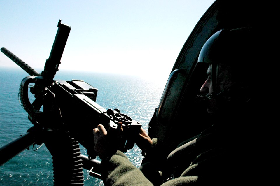 US Navy 060225-N-7130B-096 Aviation Warfare Systems Operator 2nd Class Kris Kopy prepares to test fire a .50 caliber aircraft machine gun from a HH-60H Seahawk helicopter