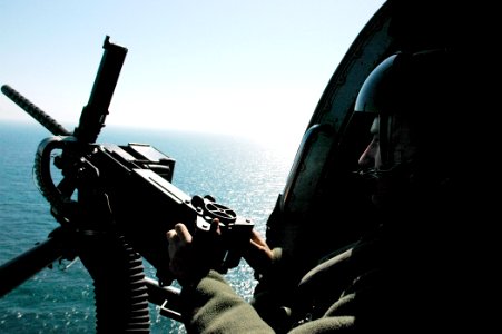 US Navy 060225-N-7130B-096 Aviation Warfare Systems Operator 2nd Class Kris Kopy prepares to test fire a .50 caliber aircraft machine gun from a HH-60H Seahawk helicopter