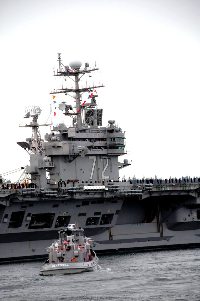 US Navy 060227-N-3390M-002 Tugboats assist the Nimitz-class aircraft carrier USS Abraham Lincoln (CVN 72) as she departs Naval Station Everett on a schedule deployment