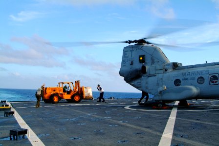 US Navy 060219-N-4772B-006 Aboard the dock landing ship USS Harpers Ferry (LSD 49) Sailors and Marines load relief supplies aboard a CH-46E Sea Knight