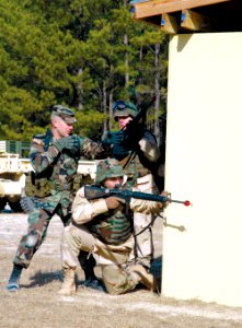 US Navy 060127-A-0000X-001 Task force Marshall, Staff Sgt. David Lyle, shows Navy personnel how to maneuver around a building during urban operations training at McCrady Training Center