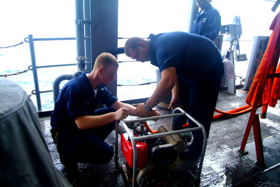 US Navy 060218-N-4772B-030 Damage Controlman Fireman Nicholas Koslowski and Damage Controlman 3rd Class Charles Andrews test a P-100 portable pump aboard the amphibious dock, landing ship USS Harpers Ferry (LSD 49)