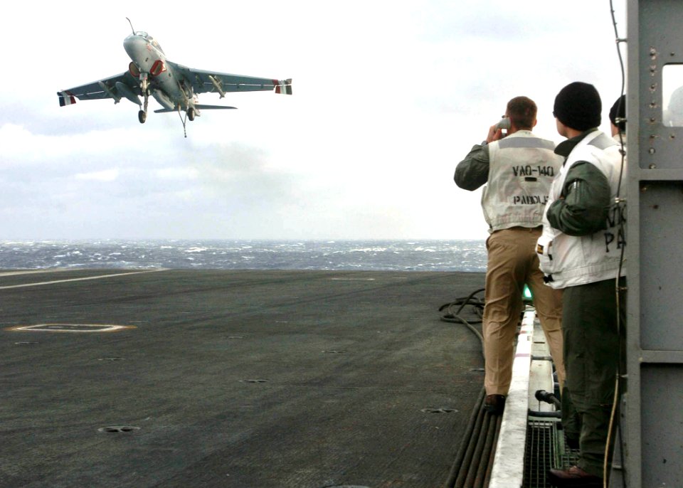 US Navy 060307-N-7359L-005 A landing signal officer observes the approach of an EA-6B Prowler assigned to the Patriots of Electronic Attack Squadron One Four Zero (VAQ-140)