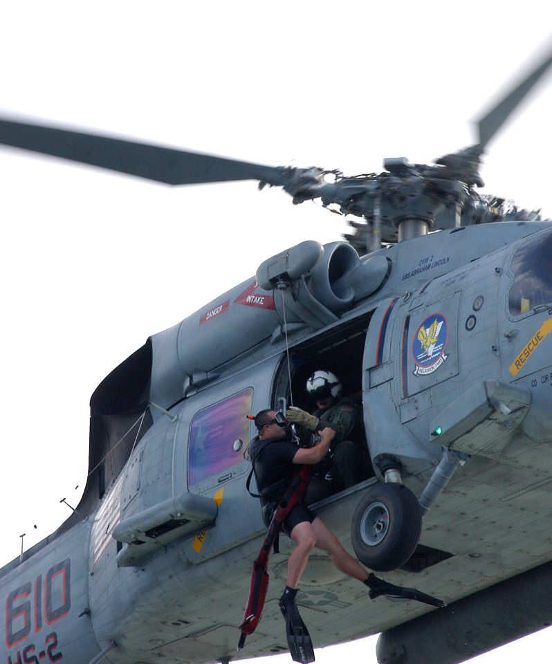 US Navy 060208-N-2832L-089 An SH-60F Seahawk helicopter assigned to the Golden Falcons of Helicopter Anti-Submarine Squadron Two (HS-2) recovers a Search and Rescue (SAR) swimmer from San Diego Bay