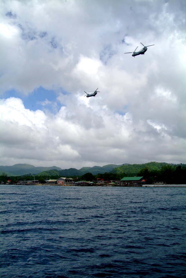 US Navy 060220-N-4772B-198 A pair of U.S. Marine Corps CH-46E Sea Knight helicopters from combat air elements of the 31st Marine Expeditionary Unit (MEU) provide equipment and personnel to aid in local relief efforts for victim