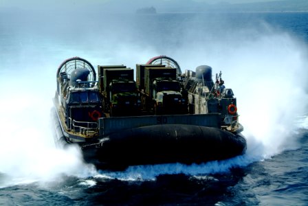 US Navy 060303-N-4772B-230 A Landing Craft, Air Cushion (LCAC) loaded with equipment from the 31st Marine Service Support Group (MSSG) makes its way toward the stern gate of the amphibious dock landing ship USS Harpers Ferry (L