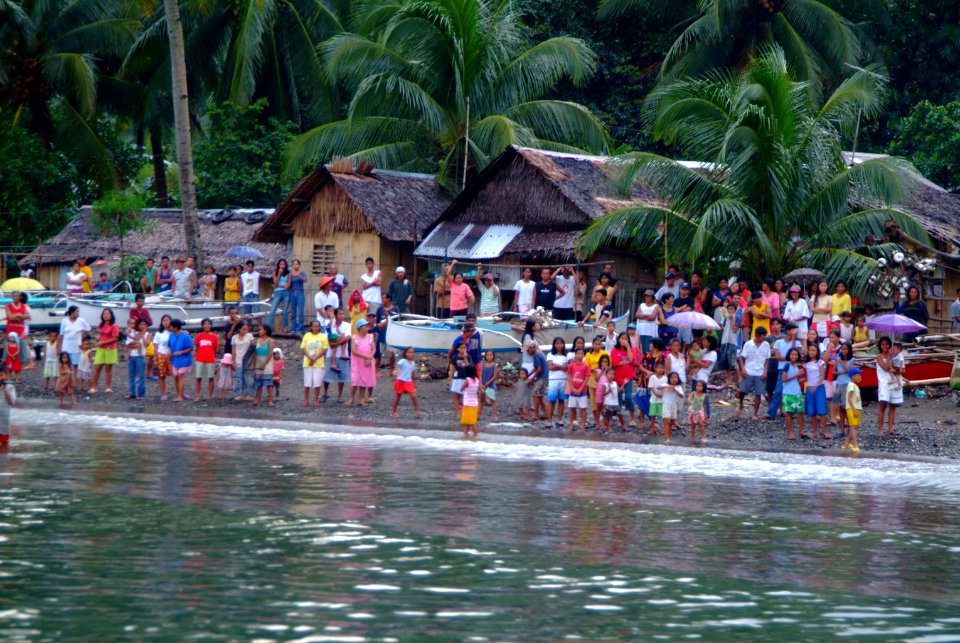 US Navy 060220-N-4772B-607 Townspeople from the small village of Himbangan greet U.S. Navy and Marine Corps personnel from the shoreline