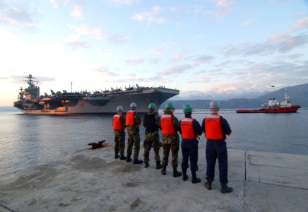 US Navy 060222-N-0780F-004 Sailors assigned to U.S. Naval Support Activity Souda Bay standby to handle mooring lines as the Nimitz-class aircraft carrier USS Theodore Roosevelt (CVN 71) arrives for a logistics stop on the Greek