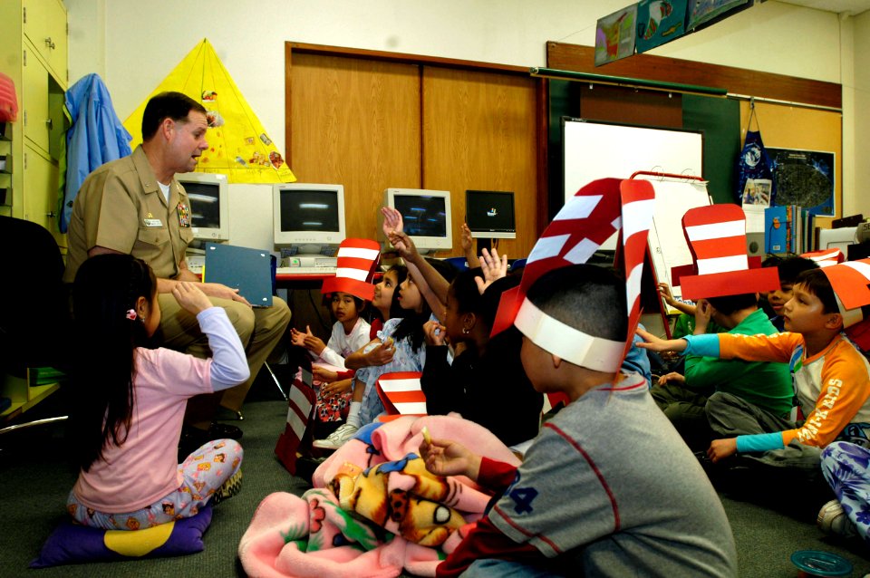 US Navy 060302-N-1960H-064 USS Kitty Hawk (CV 63) Commanding Officer, Capt. Ed McNamee, reads a book to 2nd graders at Sullivans Elementary School